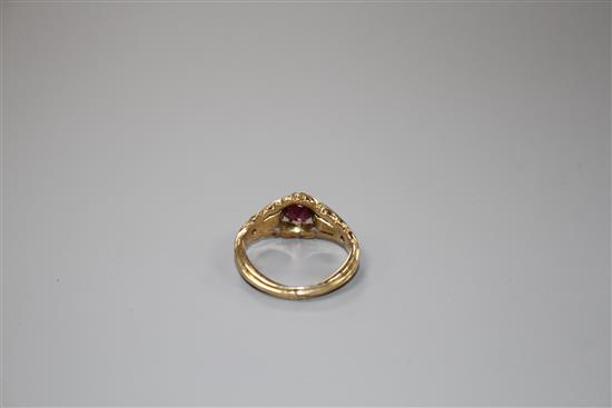 A late Victorian yellow metal and claw set solitaire garnet ring, size J, gross 4.2 grams.